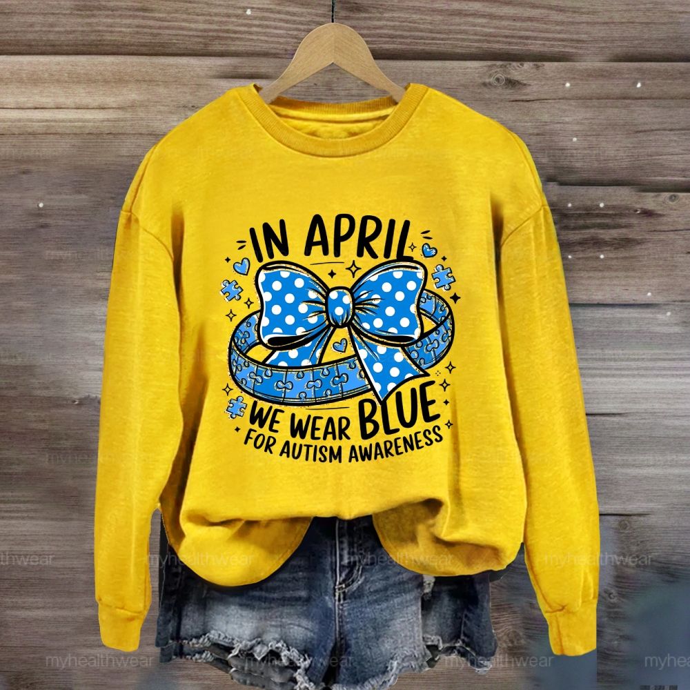 In April We Wear Blue For Autism Awareness Puzzle Pieces Polka Dots Bows Sweatshirt