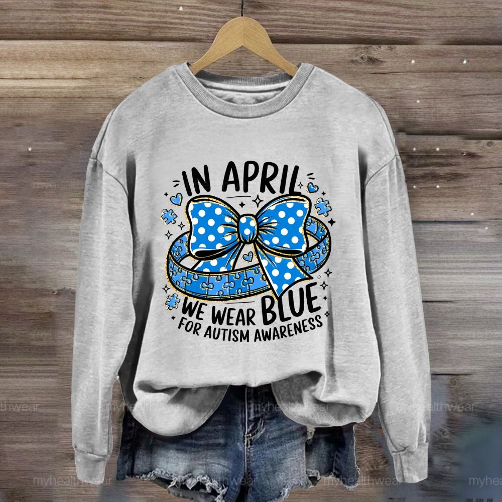 In April We Wear Blue For Autism Awareness Puzzle Pieces Polka Dots Bows Sweatshirt